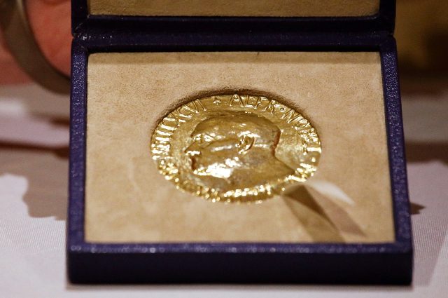 A woman holds Russian journalist Dmitry Muratov's 2021 Nobel Peace Prize medal in New York