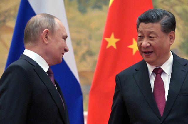 Xi Jinping (R), who has described Vladimir Putin as as 'old friend', invited the Russian l
