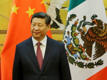 BEIJING, CHINA - NOVEMBER 13: Mexico's President Enrique Pena Nieto (L) and China's President Xi Jinping (R) stand in front of national flags during a signing ceremony after their meeting at the Great Hall of the People on November 13, 2014 in Beijing, China. (Photo by Jason Lee - Pool/Getty …