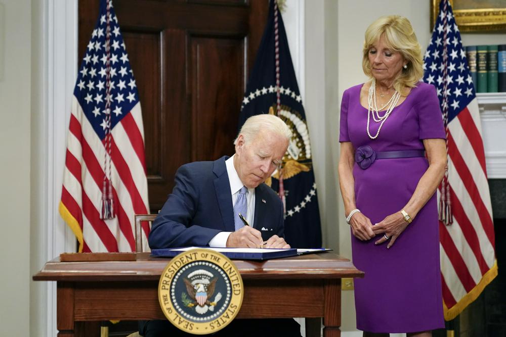 President Joe Biden signs into law S. 2938, the Bipartisan Safer Communities Act gun safety bill, in the Roosevelt Room of the White House in Washington, Saturday, June 25, 2022. First lady Jill Biden looks on at right. (AP Photo/Pablo Martinez Monsivais, File)