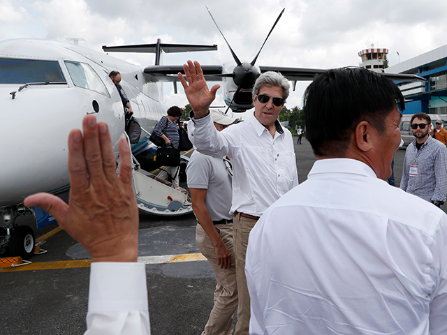 U.S. Secretary of State John Kerry waves as he prepares to board his plane to depart, Satu