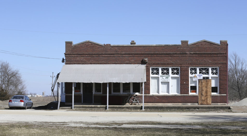 A building that housed Michael Hari's business is seen Wednesday, March 14, 2018, in Clarence, Ill. Hari, a former sheriff's deputy accused of being the ringleader in the bombing of a Minnesota mosque emerges in court documents as a sometimes-threatening figure with anti-government views who also wrote books and attracted others into his shadowy group. Hari, allegedly intended for the attack to scare Muslims into leaving the U.S. He and two associates were charged Tuesday, March 13, 2018m with traveling some 500 miles from rural Clarence, Illinois, about 120 south of Chicago, to carry out the Aug. 5, 2017 pipe-bomb assault on the Dar Al-Farooq Islamic Center in Bloomington, Minnesota. (AP Photo/Teresa Crawford)
