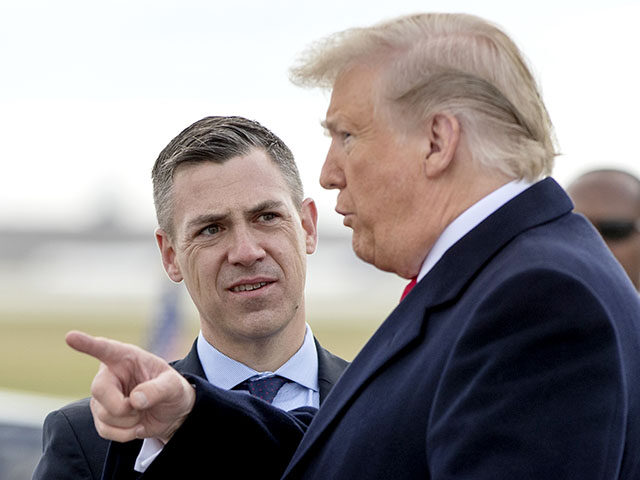 FILE - In this Oct. 27, 2018 file photo, President Donald Trump is greeted by Rep. Jim Banks, R-Ind., as he arrives at Indianapolis International Airport in Indianapolis. House Speaker Nancy Pelosi is rejecting two Republicans tapped by House GOP Leader Kevin McCarthy to sit on a committee investigating the …