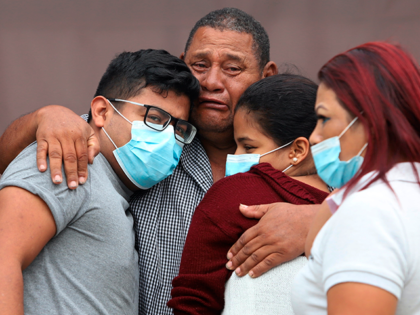 Relatives of inmates at Bellavista prison mourn after learning their relatives are among those who were killed the previous day during a riot at the prison, outside the morgue in Santo Domingo de los Tsachilas, Ecuador, Tuesday, July 19, 2022. (AP Photo)