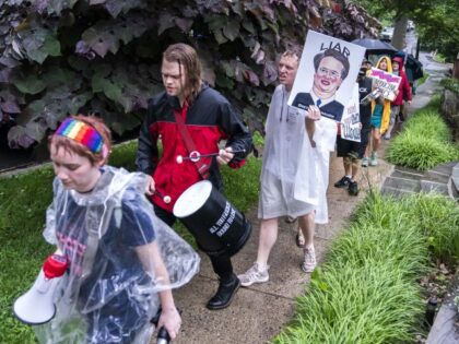 Protesters march past Supreme Court Justice Brett Kavanaugh's home on June 8, 2022, in Chevy Chase, Maryland. An armed man was arrested near Kavanaugh's home Wednesday morning as the court prepares to announce decisions for about 30 cases. (Nathan Howard/Getty Images)