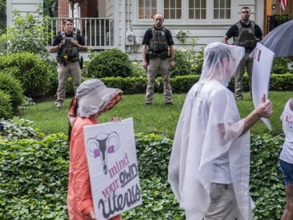 Protesters march past Supreme Court Justice Brett Kavanaugh's home on June 8, 2022 in Chevy Chase, Maryland. An armed man was arrested near Kavanaugh's home Wednesday morning as the court prepares to announce decisions for about 30 cases. (Nathan Howard/Getty Images)