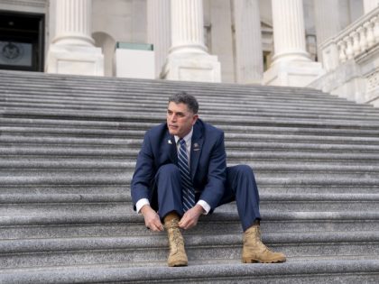 Representative Andrew Clyde (R-GA) ties his boots following a group photo in Washington, DC, on Monday, Jan. 4, 2021. (Stefani Reynolds/Bloomberg via Getty Images)