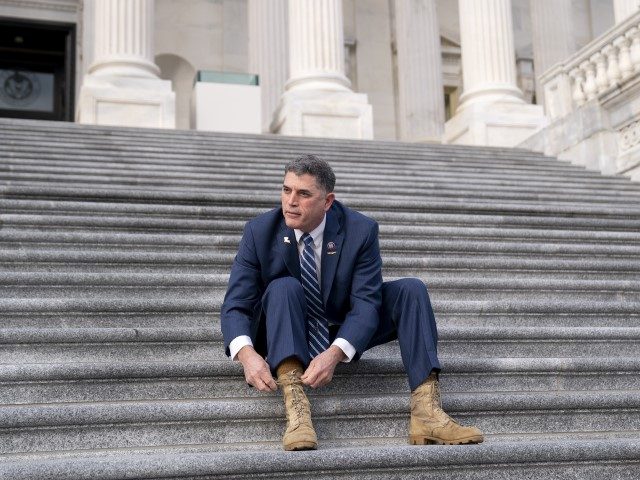Representative Andrew Clyde (R-GA) ties his boots following a group photo in Washington, D