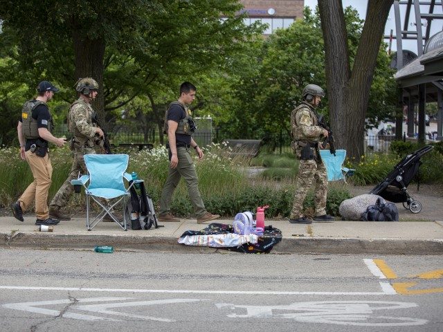 Law enforcement works the scene after a mass shooting at a Fourth of July parade on July 4, 2022 in Highland Park, Illinois. Reports indicate at least six people were killed and more than 20 injured in the shooting. (Jim Vondruska/Getty Images)