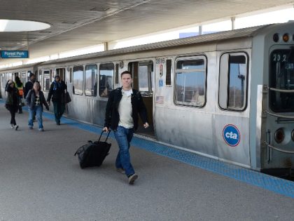 Travelers and commuters arrive at the Chicago Transit Authority's Rosemont station and head towards shuttle busses after a train derailment shut down the CTA's O'Hare International Airport station on March 24, 2014 in Chicago, Illinois. More than 30 were injured when a train, arriving at O'Hare, slammed into the platform …