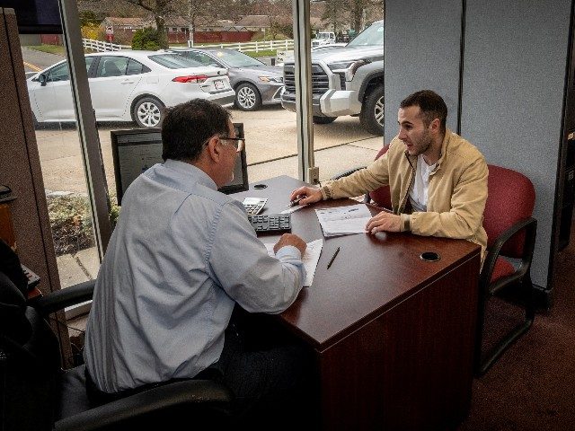 Shaun O'Connell talking with new car sales David Moshinsky at Smithtown Toyota in Smithtow