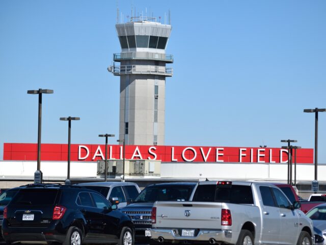 Air traffic control tower at Dallas Love Field, cars at parking lot in the foreground. (Photo by: HUM Images/Universal Images Group via Getty Images)