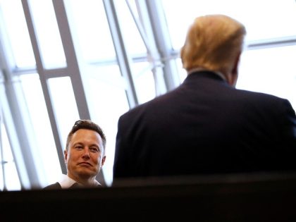 Tesla and SpaceX Chief Executive Officer Elon Musk speaks with President Donald Trump spea