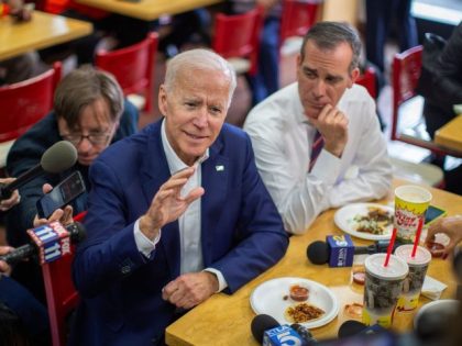 Former US Vice President and front-running Democratic presidential candidate Joe Biden talks to reporters with Los Angeles Mayor Eric Garcetti (R) during a campaign stop at a King Taco shop in Los Angeles, California on May 8, 2019. (Photo by DAVID MCNEW / AFP) (Photo credit should read DAVID MCNEW/AFP …