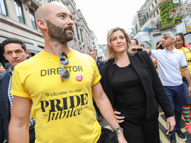 LONDON, ENGLAND - JULY 06: Michael Salter Church, Secretary of State for Defence Penny Mordaunt and London Mayor Sadiq Khan during the parade at Pride in London 2019 on July 06, 2019 in London, England. (Photo by Tristan Fewings/Getty Images for Pride in London)