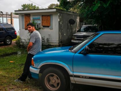 A man stands outside his trailer at The Manatee Mobile Home & RV Park in Fort Pierce, Florida on September 2, 2019. - Monster storm Dorian stalled over the Bahamas Monday as surging seawaters and ferocious winds sowed chaos in low-lying island communities, claiming at least five lives and spurring …