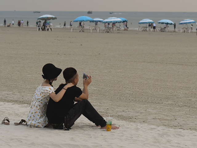 A couple seen on Silver Beach in Beihai during cloudy weather. Silver Beach, located 8km f
