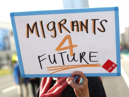 BERLIN, GERMANY - SEPTEMBER 04: A demonstrator holds a banner reading Migrants 4 future du