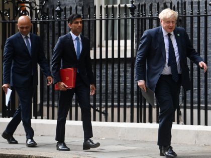 Britain's Prime Minister Boris Johnson (R), Britain's Health Secretary Sajid Javid (L) and Britain's Chancellor of the Exchequer Rishi Sunak (C) arrive to speak at a press conference at the Downing Street Briefing Room in central London on September 7, 2021. - Breaking an election pledge not to raise taxes, …