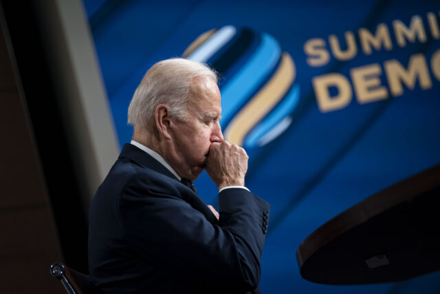 U.S. President Joe Biden coughs during the virtual Summit for Democracy in the Eisenhower