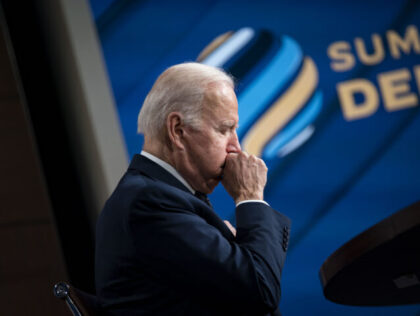 U.S. President Joe Biden coughs during the virtual Summit for Democracy in the Eisenhower Executive Office Building in Washington, D.C., U.S., on Thursday, Dec. 9, 2021. Biden warned of the need to vigilantly protect democratic values at the start of the two-day summit that has stoked tensions with China and …