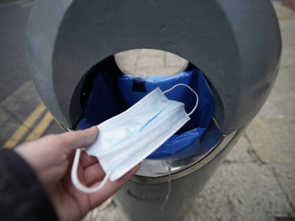 A face mask is thrown into a bin in Dublin, Ireland as mask-wearing is no longer mandatory in Ireland, and politicians hailed the day as a "milestone" moment after two years of the coronavirus pandemic.. Picture date: Monday February 28, 2022. (Photo by Niall Carson/PA Images via Getty Images)