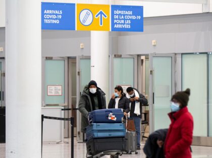 Travelers wearing face masks are seen at the arrivals hall of Toronto Pearson International Airport in Mississauga, Ontario, Canada, on April 1, 2022. Border measures were eased in Canada on Friday as fully vaccinated travelers no longer need pre-arrival COVID-19 testing to enter Canada either by land or air. (Photo …