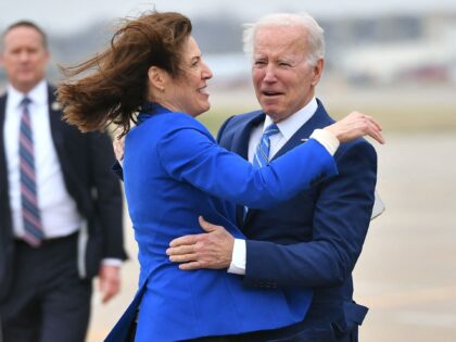 US President Joe Biden is greeted by Rep. Cindy Axne (D-IA-03) and Des Moines Mayor Frank