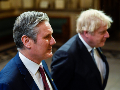 LONDON, ENGLAND - MAY 10: British Labour Party opposition leader Keir Starmer and British Prime Minister Boris Johnson proceed through the Members' Lobby ahead of the State Opening of Parliament in the House of Lords at the Palace of Westminster on May 10, 2022 in London, England. The State Opening …