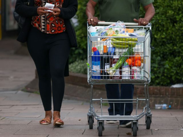 A customer pushes a shopping trolley full of groceries at an Aldi Stores Ltd. supermarket in London, UK, on Friday, June 24, 2022. The Office for National Statistics said Friday the volume of goods sold in stores and online fell 0.5% in May, as soaring food prices forced consumers to …