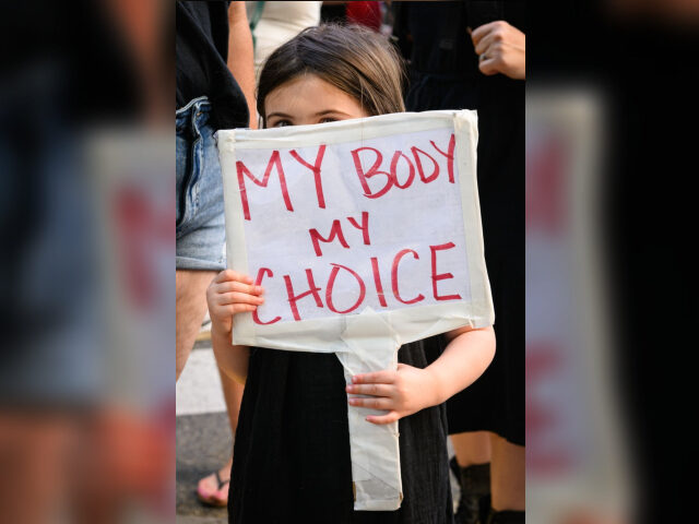 PORTLAND, OR - JUNE 24: A girl holds a sign reading "My body my choice" as people gather t