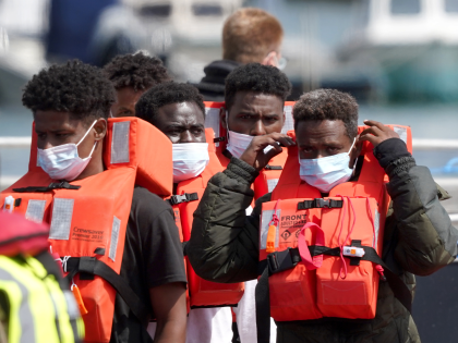 A group of people thought to be migrants are brought in to Dover, Kent, following a small