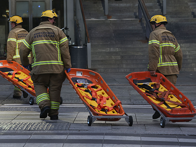 Members of the emergency services bring stretchers at the scene of the Fields shopping center in Copenhagen, Denmark, on July 3, 2022 following a shooting. - Gunfire in a Copenhagen mall left "several dead," and several wounded Danish police said. - Denmark OUT (Photo by Olafur Steinar Gestsson / Ritzau …