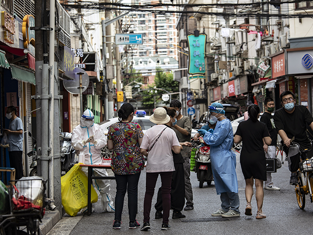 Healthcare worker in protective gear assist residents for Covid-19 tests in Shanghai, Chin