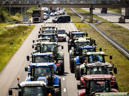 Farmers take part in a blockade of the A67 near Eindhoven to protest against government plans that may require them to use less fertilizer and reduce livestock at Hapert, on July 4, 2022. - Netherlands OUT (Photo by ROB ENGELAAR / ANP / AFP) / Netherlands OUT (Photo by ROB …