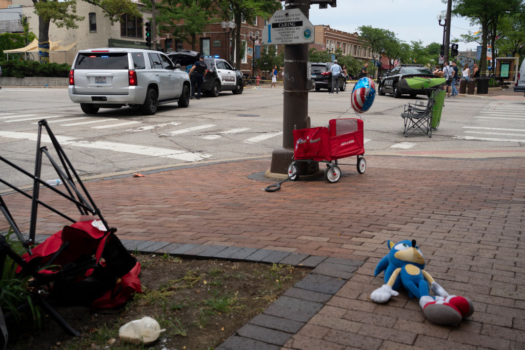 Toys and lawn chairs lay along the scene of the Fourth of July parade shooting in Highland Park, Illinois on July 4, 2022. - A shooter opened fire Monday during a parade to mark US Independence Day in the state of Illinois, killing at least six people, officials said. "At this time, two dozen people have been transported to Highland Park hospital. Six are confirmed deceased," Commander Chris O'Neil of the city's police told journalists. The suspected shooter, who is still at large, has been described as a white male aged 18-20 with longer black hair, O'Neil said. (Photo by Youngrae Kim / AFP) (Photo by YOUNGRAE KIM/AFP via Getty Images)
