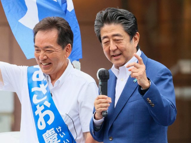 This picture taken on July 6, 2022 shows former Japanese Prime Minister Shinzo Abe (R) delivering a campaign speech for the ruling Liberal Democratic Party (LDP) candidate Keiichiro Asao for the Upper House election in Yokohama, suburban Tokyo. - Japan's former prime minister Shinzo Abe was shot at a campaign event on July 8, 2022, a government spokesman said, as local media reported the nation's longest-serving premier was showing no vital signs. (Photo by Yoshikazu Tsuno / AFP) (Photo by YOSHIKAZU TSUNO/AFP via Getty Images)