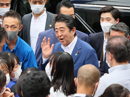 This picture taken on July 6, 2022 shows former Japanese Prime Minister Shinzo Abe (C) meeting with supporters after he delivered a campaign speech for the ruling Liberal Democratic Party (LDP) candidate Keiichiro Asao for the Upper House election in Yokohama, suburban Tokyo. - Japan's former prime minister Shinzo Abe …