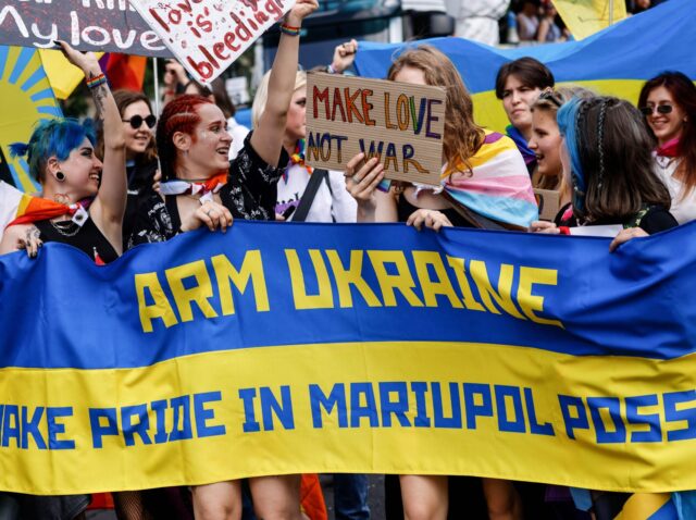 Participants hold a banner in Ukrainian colours reading "Arm Ukraine- make Pride in Mariupol possible" during the 44th Christopher Street Day (CSD) demonstration during Pride month in Berlin on July 23, 2022. - Members of the LGBTIQA+ community and their allies take to the streets under the motto "United in …