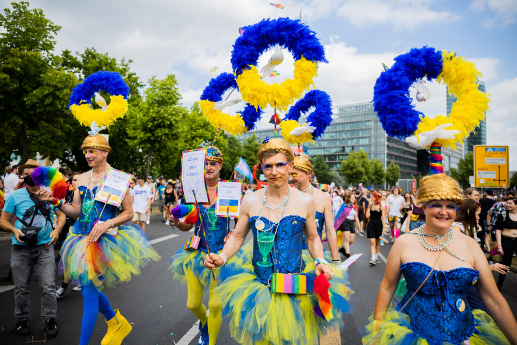 23 July 2022, Berlin: Participants wear headdresses in the colors of Ukraine with dove of peace at Christopher Street Day (CSD). This year's motto of the parade for the rights of lesbian, gay, bisexual, transgender, intersex and queer people is "United in Love! Against hate, war and discrimination." Photo: Christoph Soeder/dpa (Photo by Christoph Soeder/picture alliance via Getty Images)
