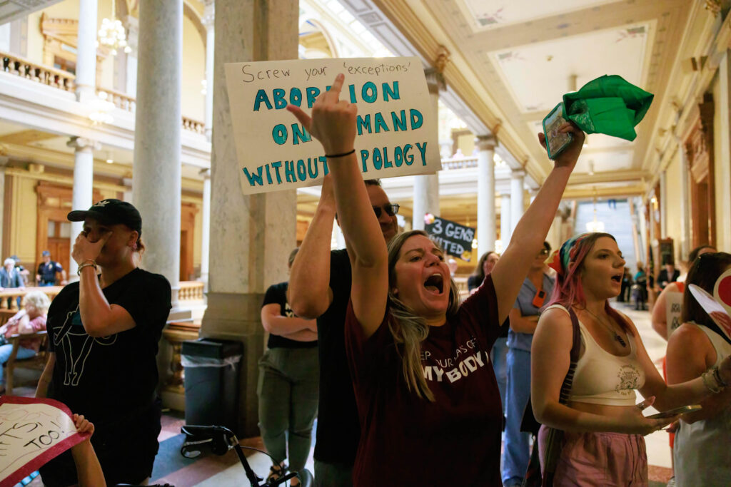 INDIANAPOLIS, INDIANA, UNITED STATES - 2022/07/25: (Editors note image depicts profanity) Abortion-rights protesters argue with anti-abortion activists inside the Indiana State house during the demonstration. As the legislature is holding a special session to consider curtailing abortion rights in the wake of the U.S. Supreme Court ruling overturning Roe v. Wade last month, abortion rights activists protested in Indianapolis. (Photo by Jeremy Hogan/SOPA Images/LightRocket via Getty Images)