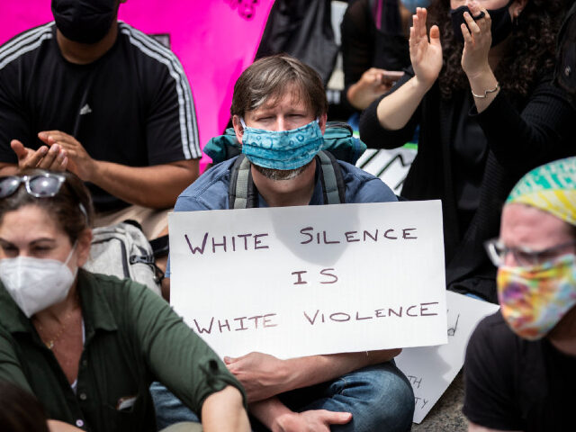 MANHATTAN, NY - JUNE 02: A white protester holds a sign that says, "White Silence is White
