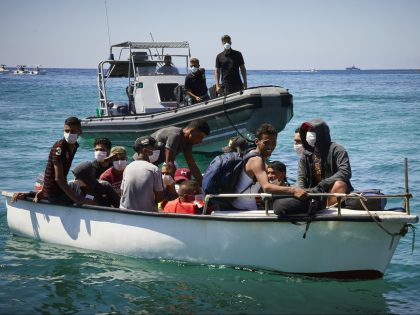 LAMPEDUSA, ITALY - AUGUST 28: Migrants from Tunisia dock their boat at a port on August 28