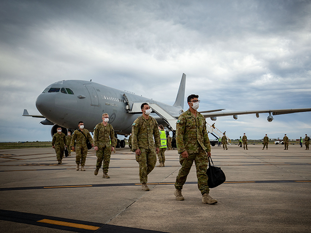 Australian Defence Force troops disembark an Australian Air Force plane at Avalon Airport