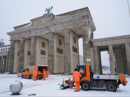 BERLIN, GERMANY - FEBRUARY 08: A crew clears ice and snow from the Brandenburg Gate on the second day of a severe snow storm across Germany on February 08, 2021 in Berlin, Germany. Heavy snow fall on an east-west swathe across central and parts of northern Germany have led to …