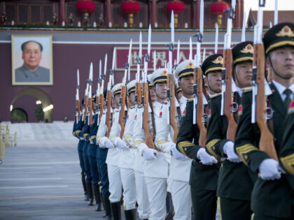 BEIJING, CHINA - MAY 01: The Guard of Honor of the Chinese People's Liberation Army (PLA) escorts the national flag during a flag-raising ceremony at the Tian'anmen Square to celebrate the International Labor Day on May 1, 2022 in Beijing, China. The International Labor Day is celebrated on May 1. …