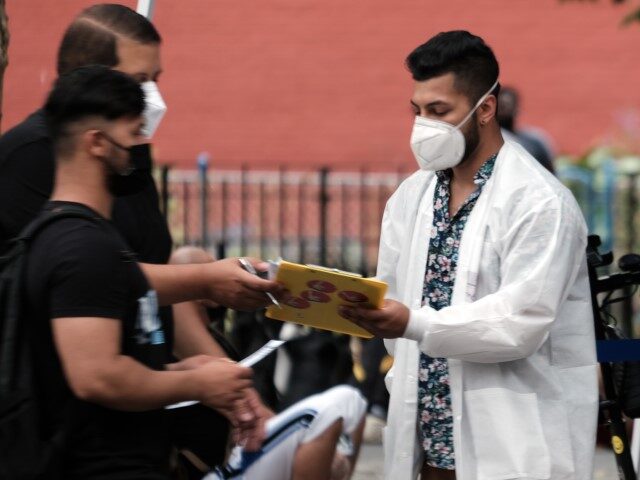 Healthcare workers with New York City Department of Health and Mental Hygiene work at intake tents where individuals are registered to receive the monkeypox vaccine on July 29, 2022 in New York City. The World Health Organization has now declared that the monkeypox outbreak, which continues to grow globally, is …