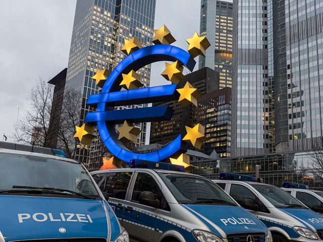 Police vans are parked before the euro symbol, at Willy Brandt square, near where some 30 pro Pegida participants gathered, surrounded by police officers and hundreds of anti Pegida demonstrators, at Hauptwache square, Frankfurt, Germany, 09 February 2015. The rally was in favor of anti Islam and anti immigration policies …