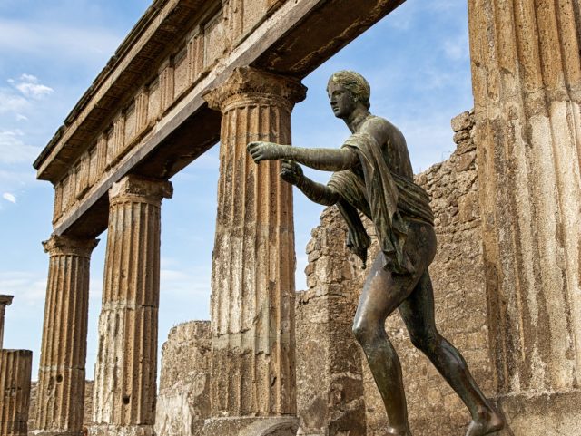 A replica of the bronze statue of Apollo, portrayed in the act of shooting arrows, at the Temple of Apollo, the oldest religious building in Pompeii, Italy.