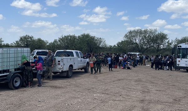 Del Rio Sector Border Patrol agents provide a water tanker for migrants who just crossed the border near Eagle Pass, Texas, on July 5. (Randy Clark/Breitbart Texas)